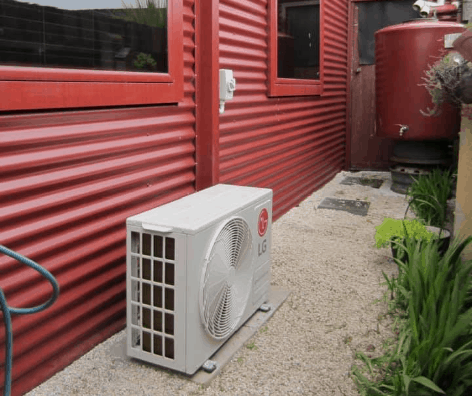 LG heat pump outdoor unit mounted on the side of a Tasmanian home