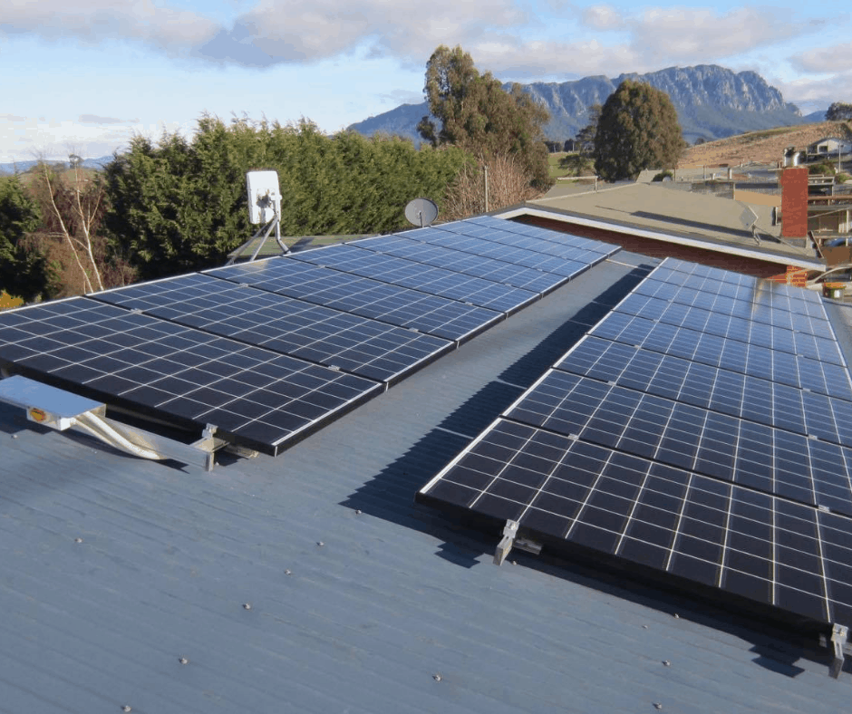 Roof top solar panels on a Tasmanian home with Mount Roland behind