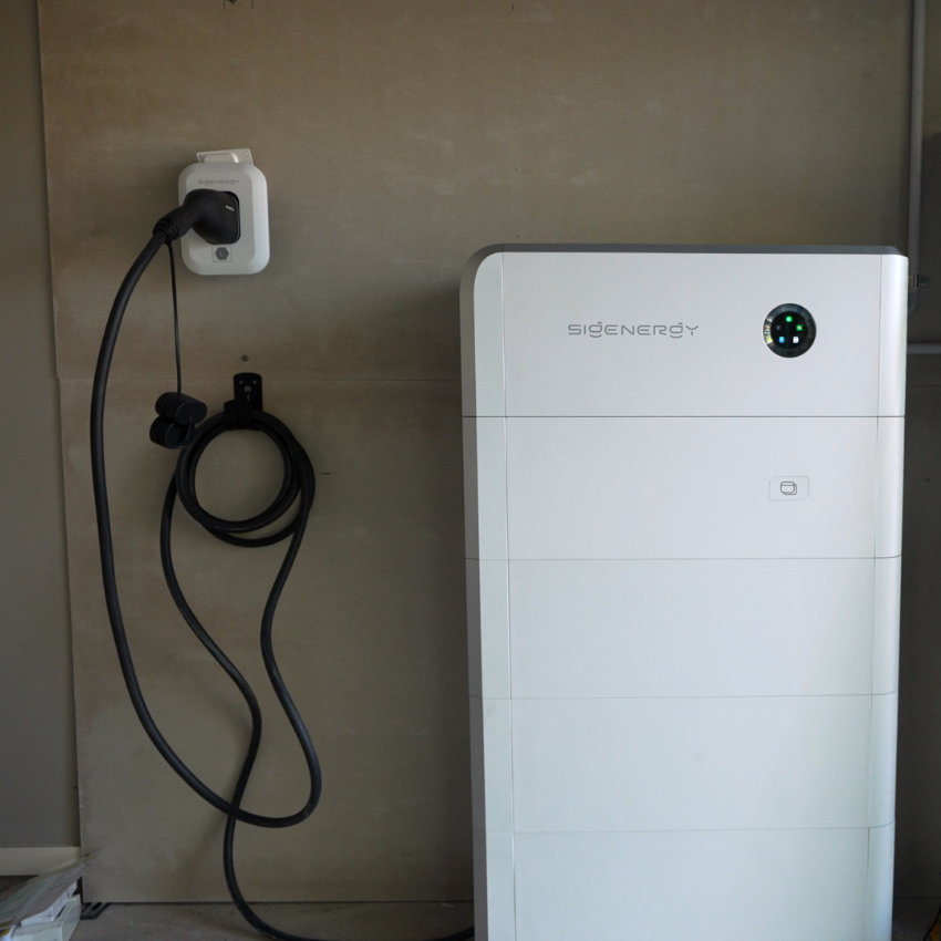 Sigenergy SigenStor battery with an EV charging cable mounted alongside it