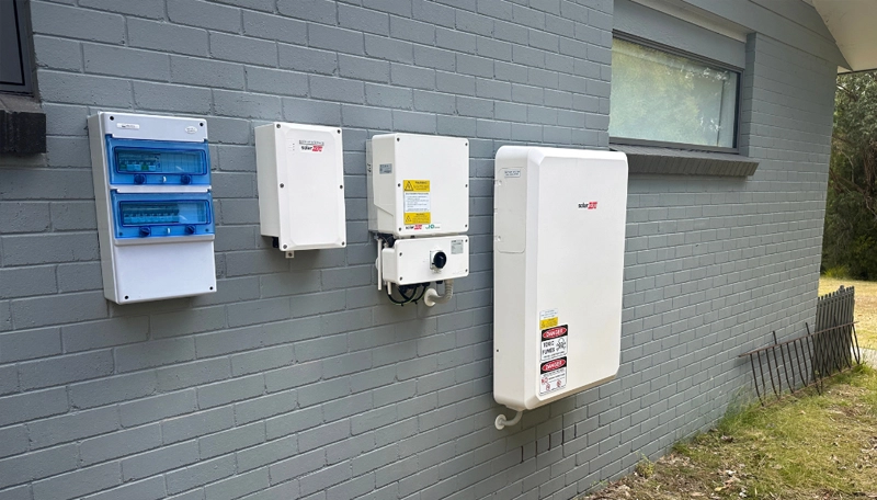 A SolarEdge battery and inverter installed on an exterior wall